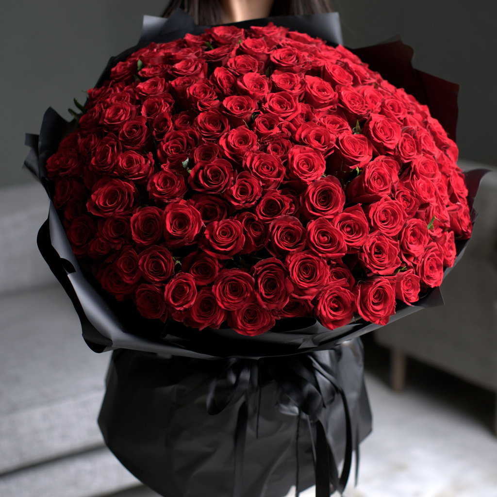 101 red roses hand-tied into a dome and wrapped in glossy black paper — same-day flower delivery in Dubai