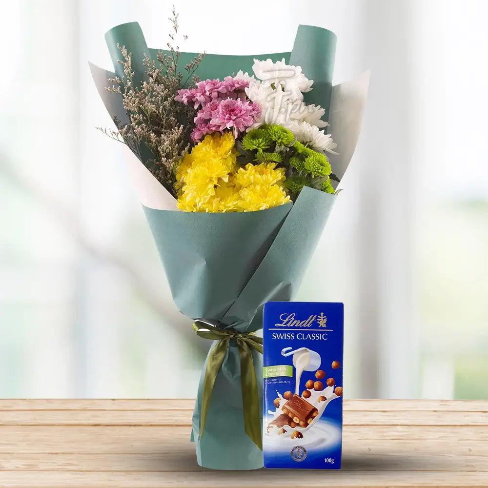 Chrysanthemums in Nice Wrapping with Lindt By Flower Delivery Dubai for illness