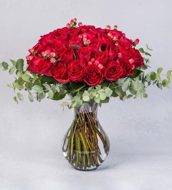 50 Red Roses with Hypericum in Vase By Flower Delivery Dubai for him