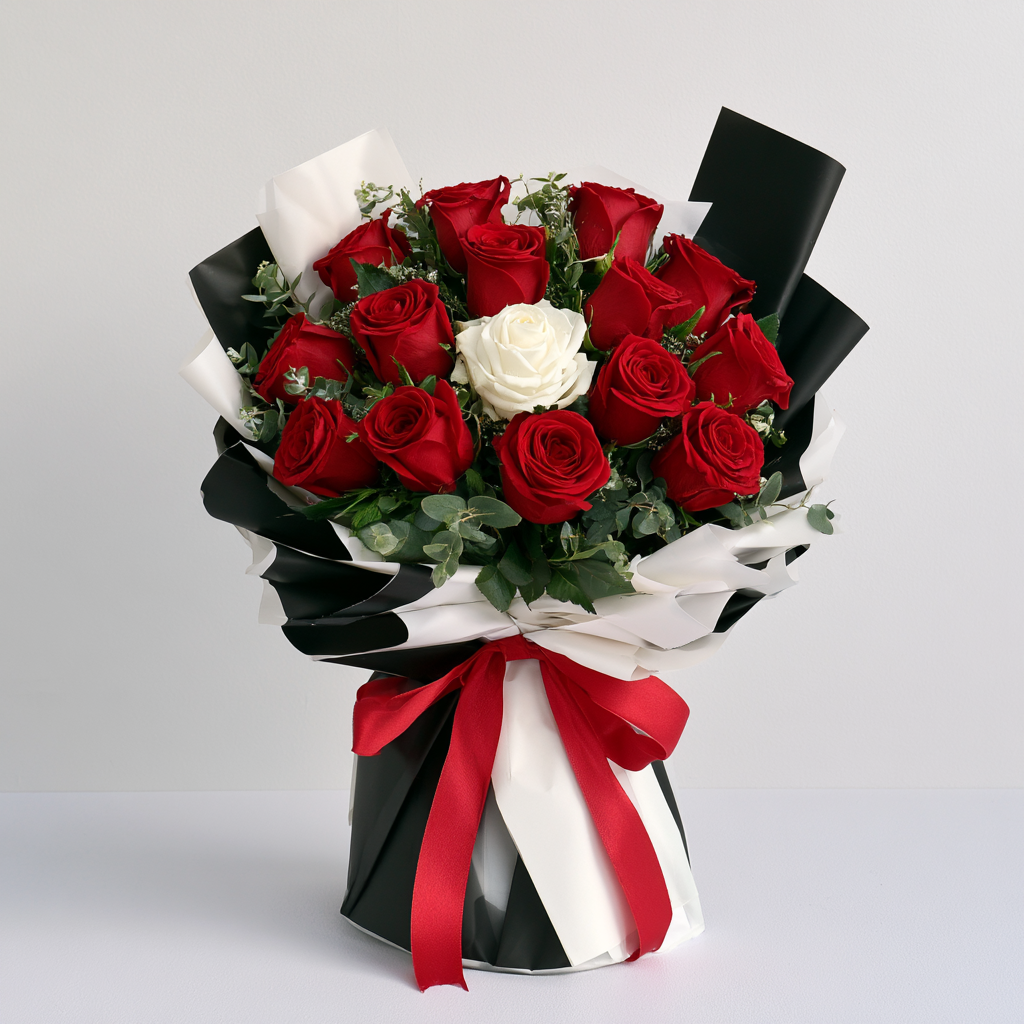 One & Only bouquet of 14 red roses with a single white rose at the centre — flower delivery in Dubai