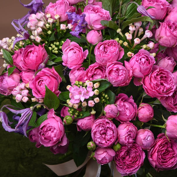 Side view of a garden rose and clematis bouquet