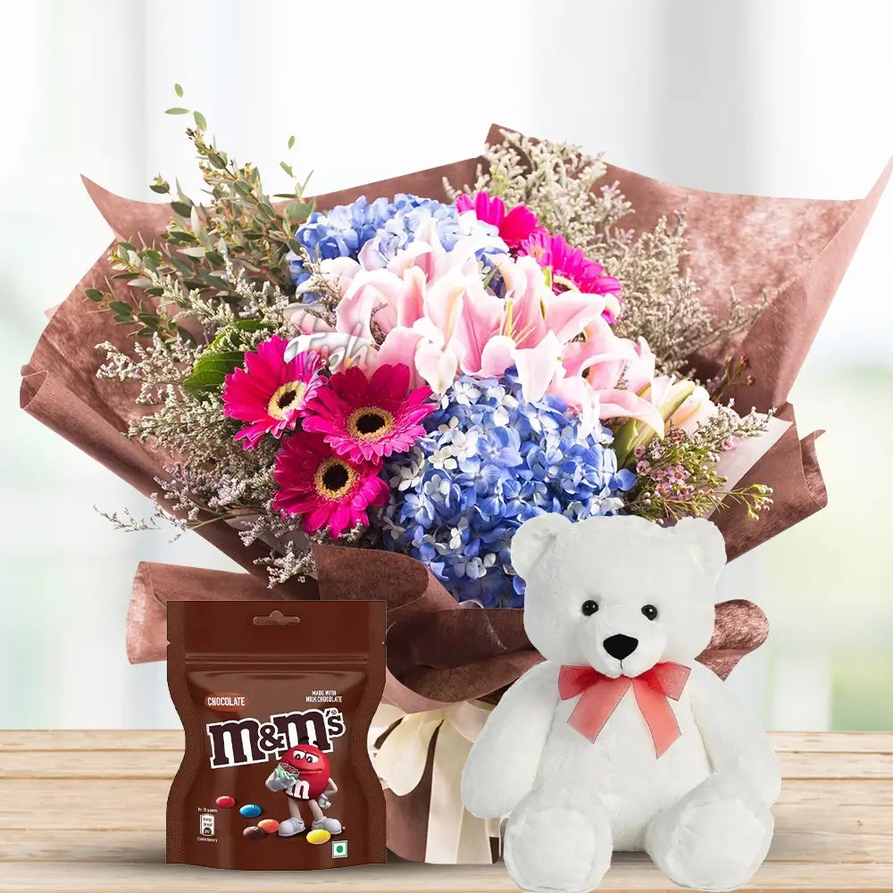 Pink Gerberas, Lilies & Blue Hydrangeas with M&M & Teddy By Flower Delivery Dubai for him